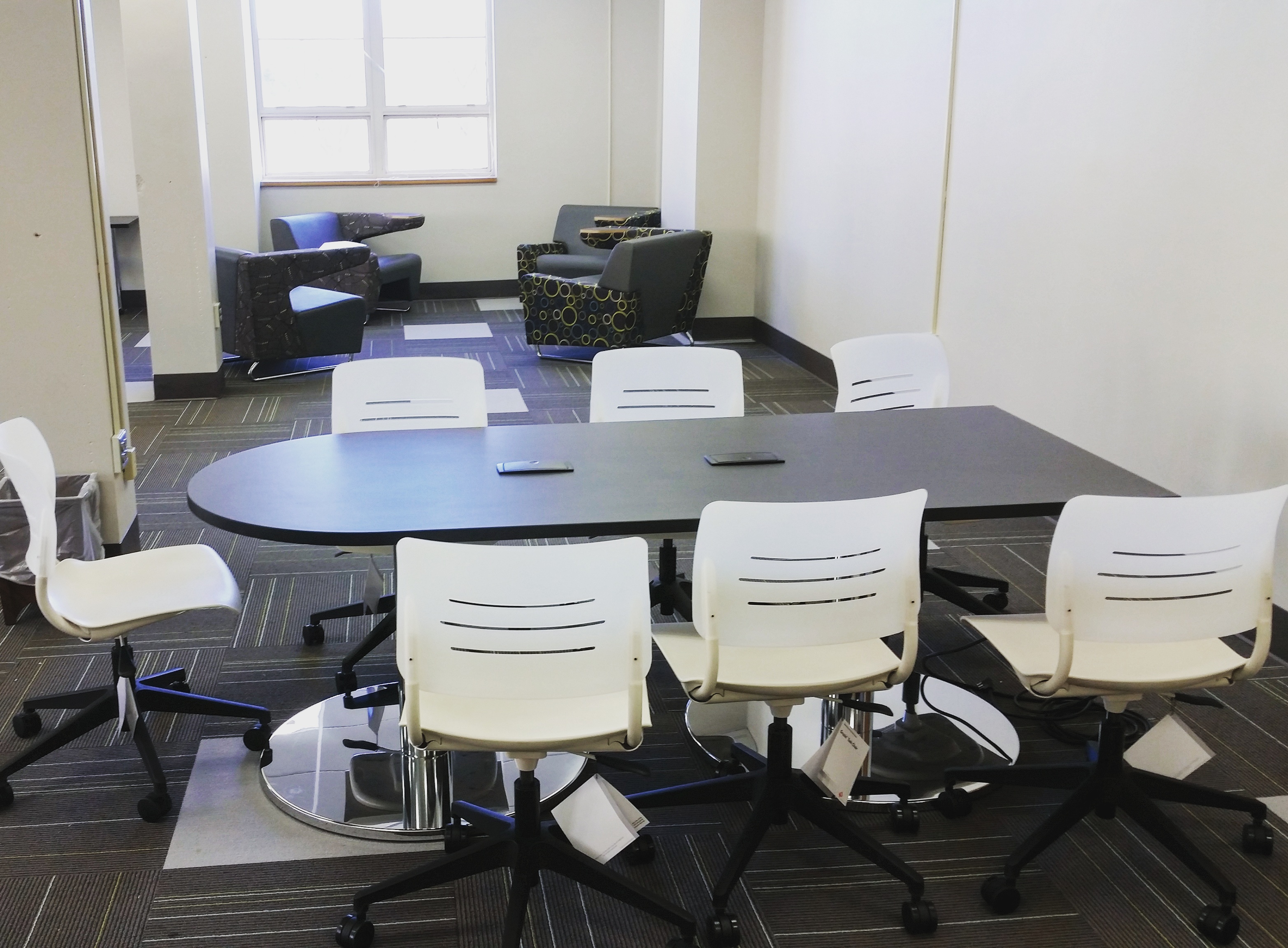 table with six rolling chairs