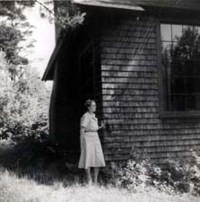 Click here to view larger image of Anna Lewis standing near New Hampshire Studio at the MacDowell Colony.
