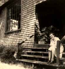 Click here to view larger image of Anna Lewis sitting on porch of the New Hampshire Studio at the MacDowell Colony.